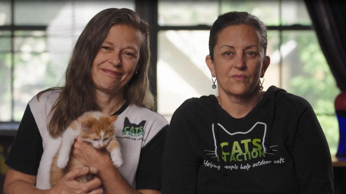 Liz and Erica, with one holding a cat